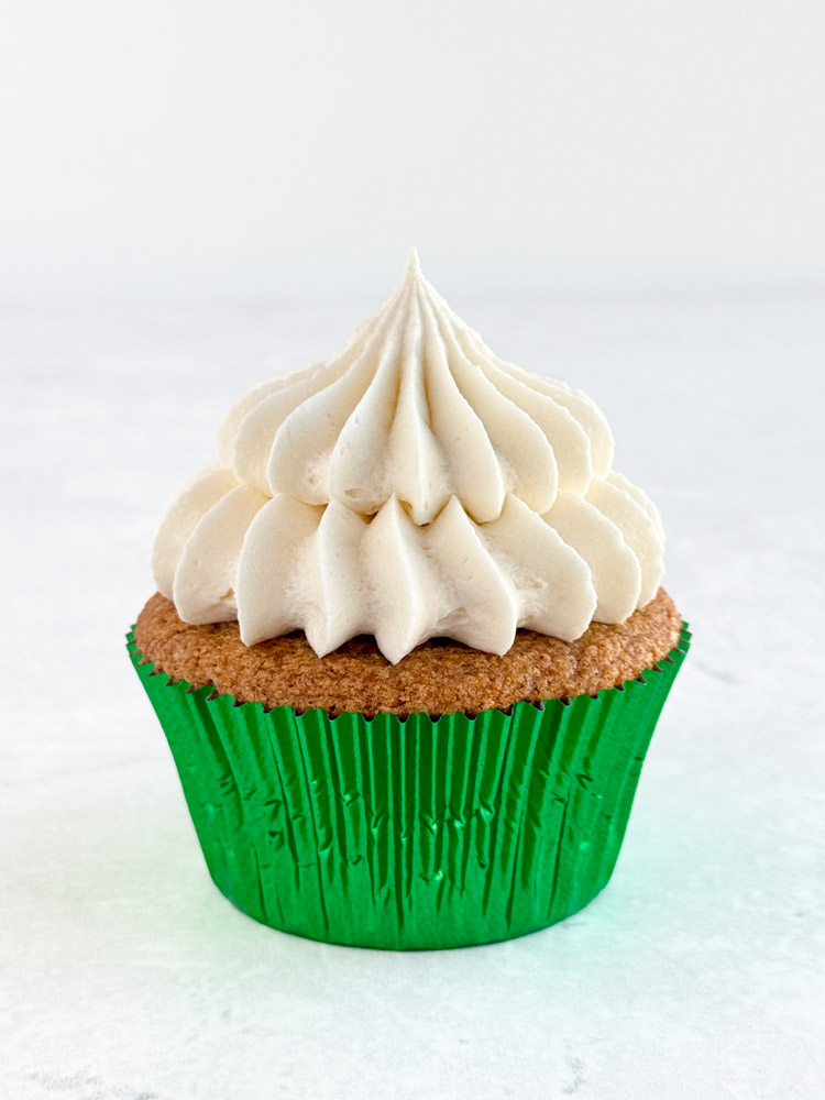 Gingerbread cupcake frosted with cream cheese frosting.