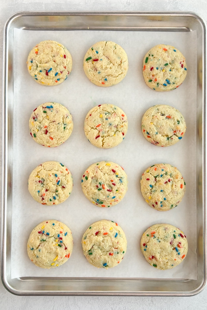 Baked cookies and a parchment lined baking sheet pan.