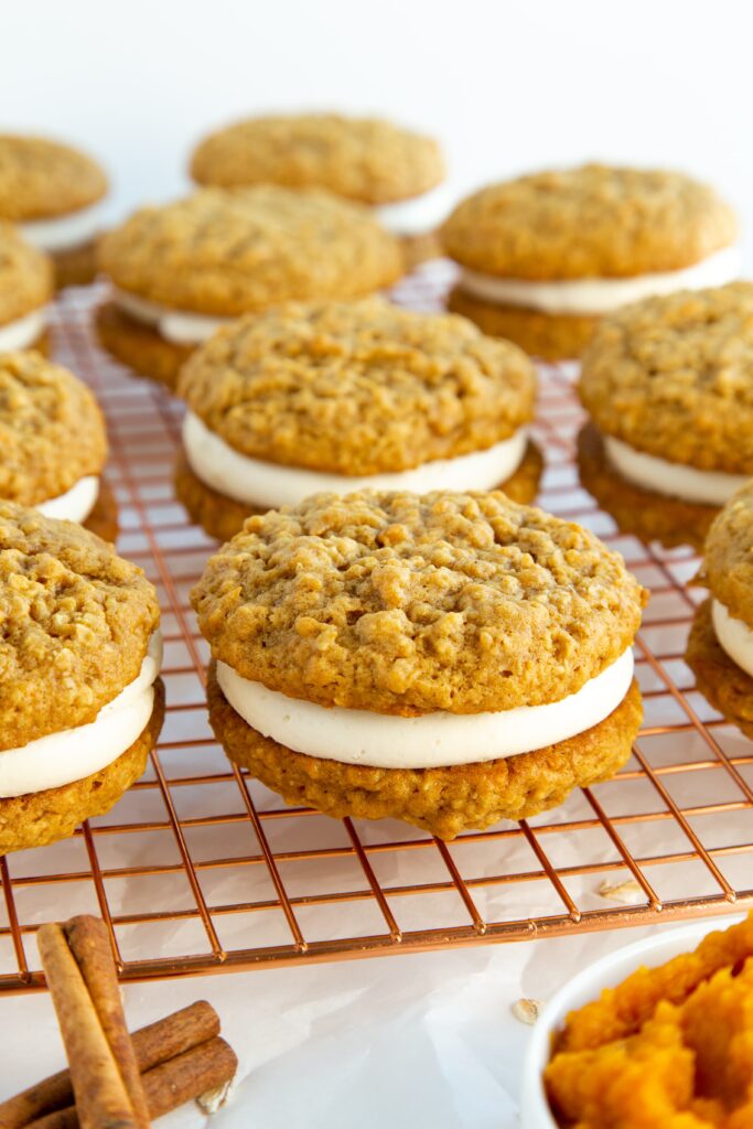 pumpkin spice oatmeal cream pies on a wire rack