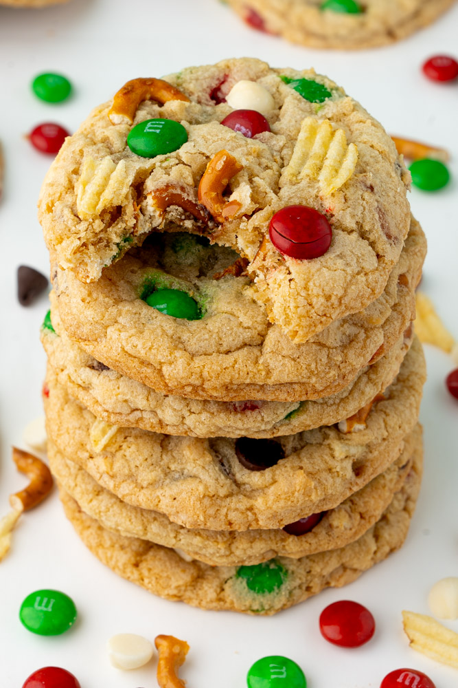 Kitchen sink Christmas cookies with a bite taken out to show the chewy interior texture.