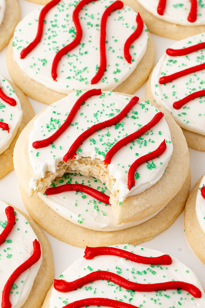 Little Debbie Christmas tree cookies with a bite taken out of the top cookie to show the interior texture.