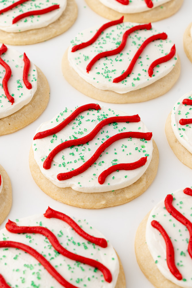 Vanilla cookies with vanilla frosting, green sugar, and red frosting stripes.