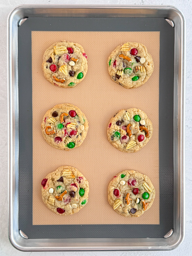 Baked kitchen sink cookies on a baking pan.