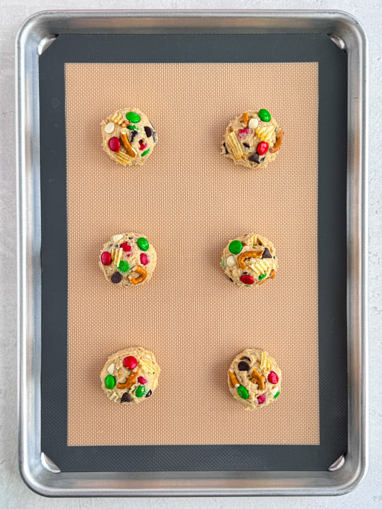 The kitchen sink cookie dough balls on a baking pan.