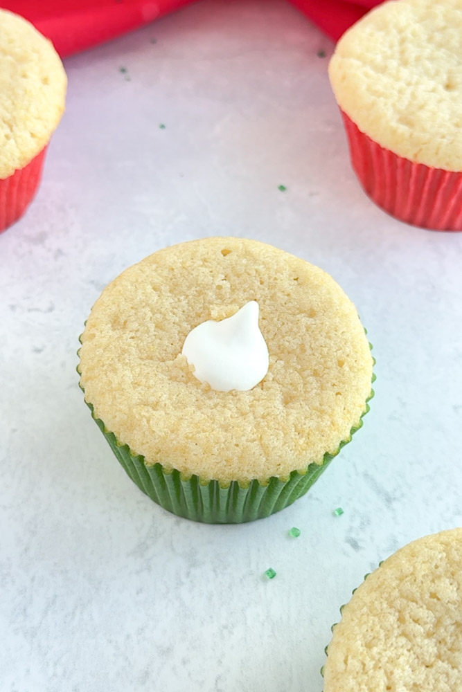 A vanilla cupcake filled with marshmallow cream filling.