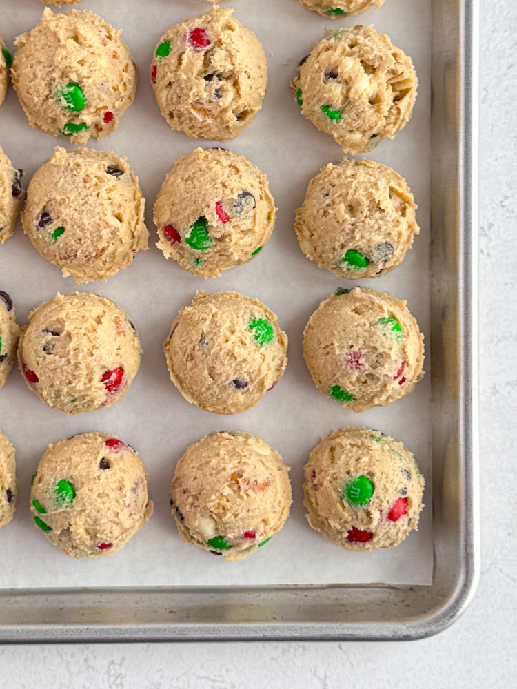 Portioned cookie dough on a baking pan.