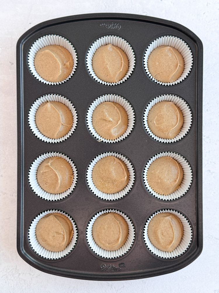 Gingerbread cupcake batter in a cupcake pan.