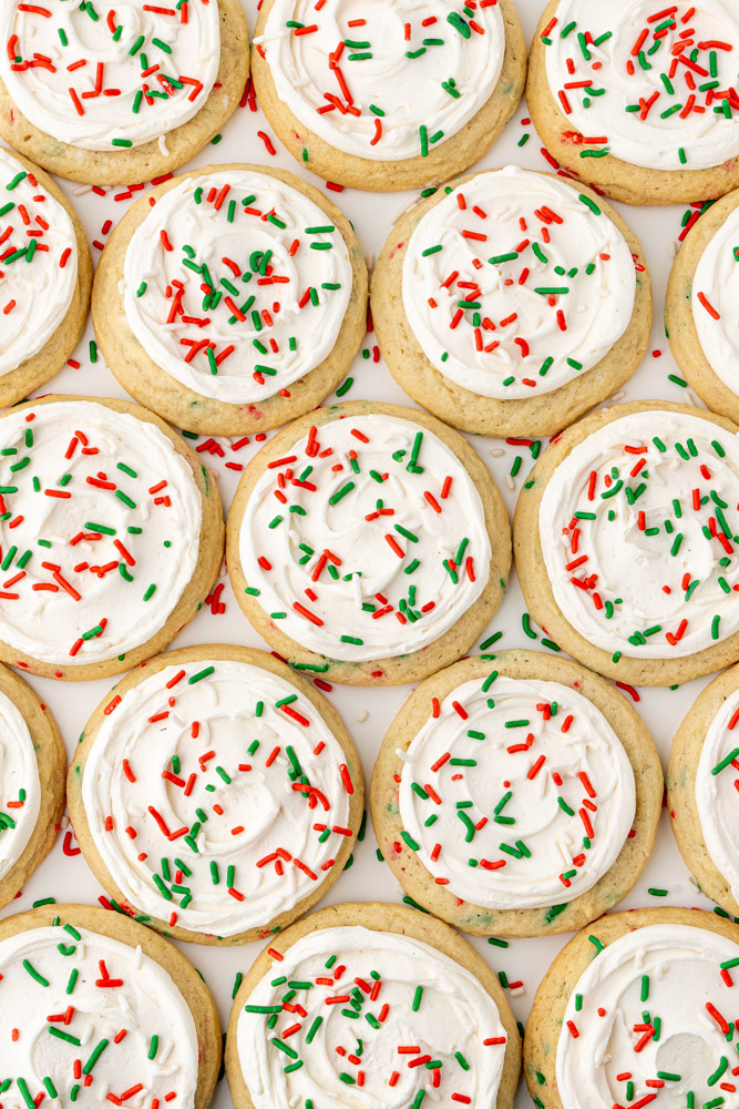 Chewy Christmas sugar cookies with vanilla buttercream and holiday sprinkles.