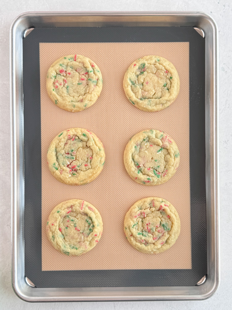 Baked sugar cookies on a baking sheet pan.