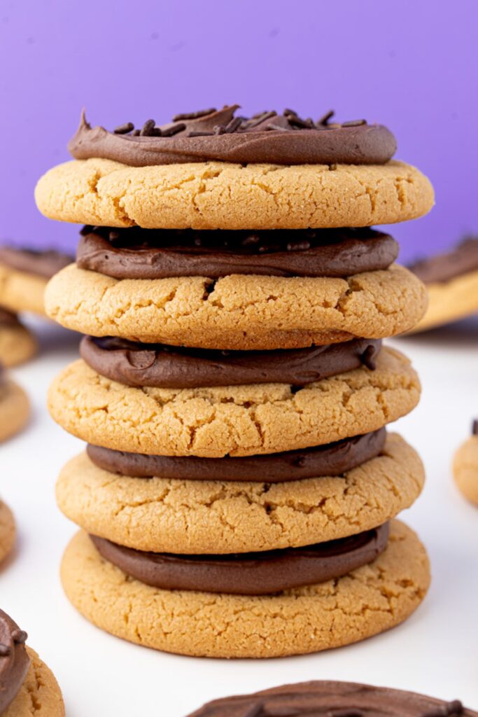 A stack of the frosted chocolate peanut butter cookies.