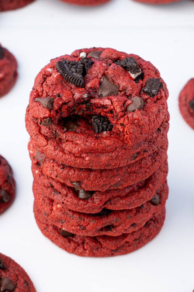 A bite out of an Oreo red velvet cookie to show the interior chewy texture.