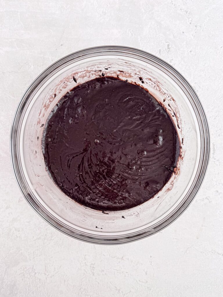 Brownie batter in a glass bowl.