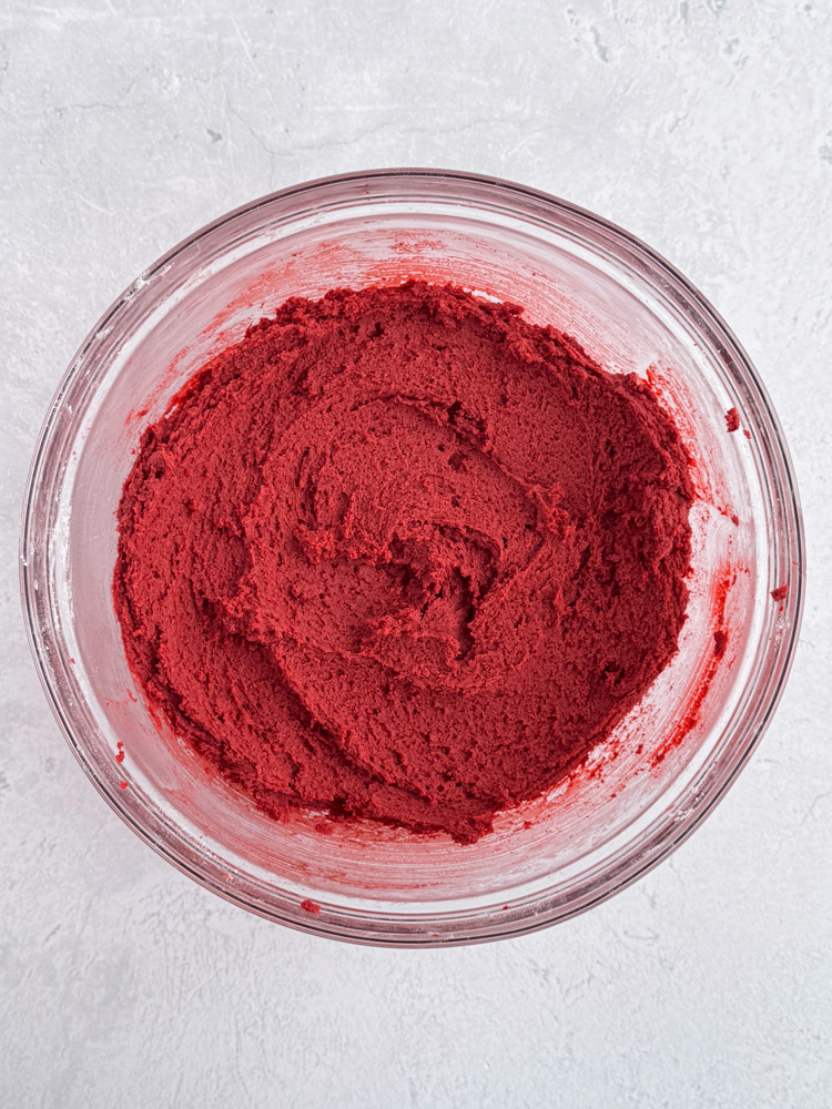 Red velvet cookie dough in a glass bowl.