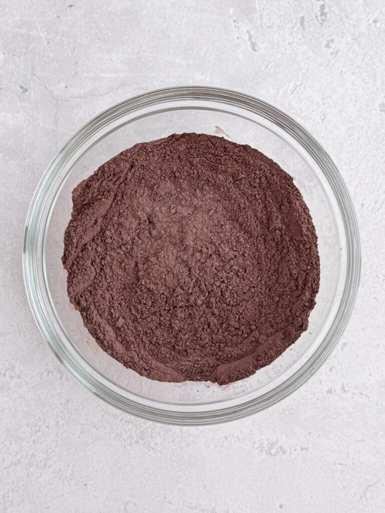 Flour and cocoa powder mixture in a glass bowl.