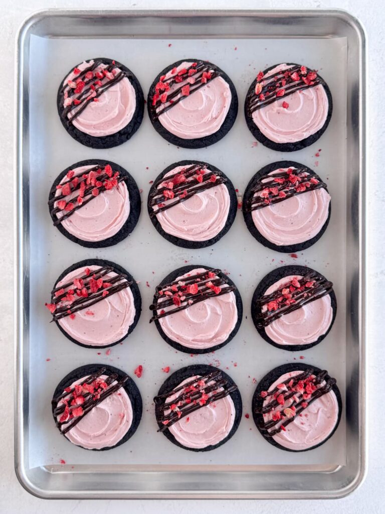 Frosted and decorated cookies on a baking sheet pan.