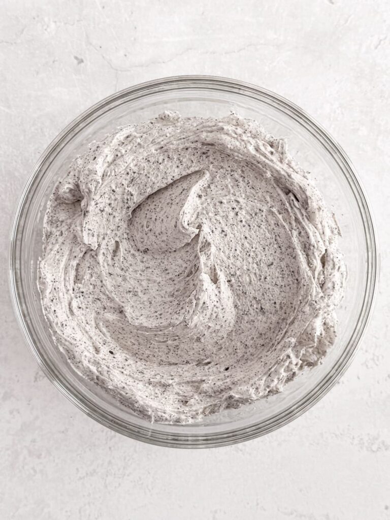 Cookies and cream buttercream frosting in a mixing bowl.