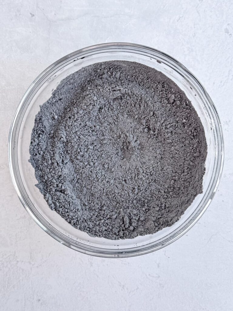 Flour and cocoa powder mixture in a glass mixing bowl.