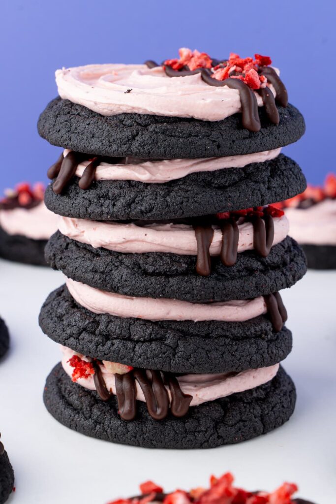 A stack of strawberry frosted chocolate cookies.