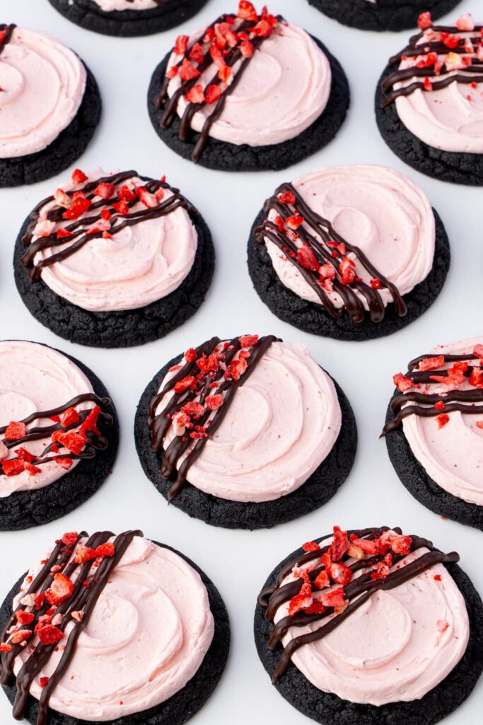 Chocolate cookies with strawberry buttercream frosting and chocolate ganache drizzle.