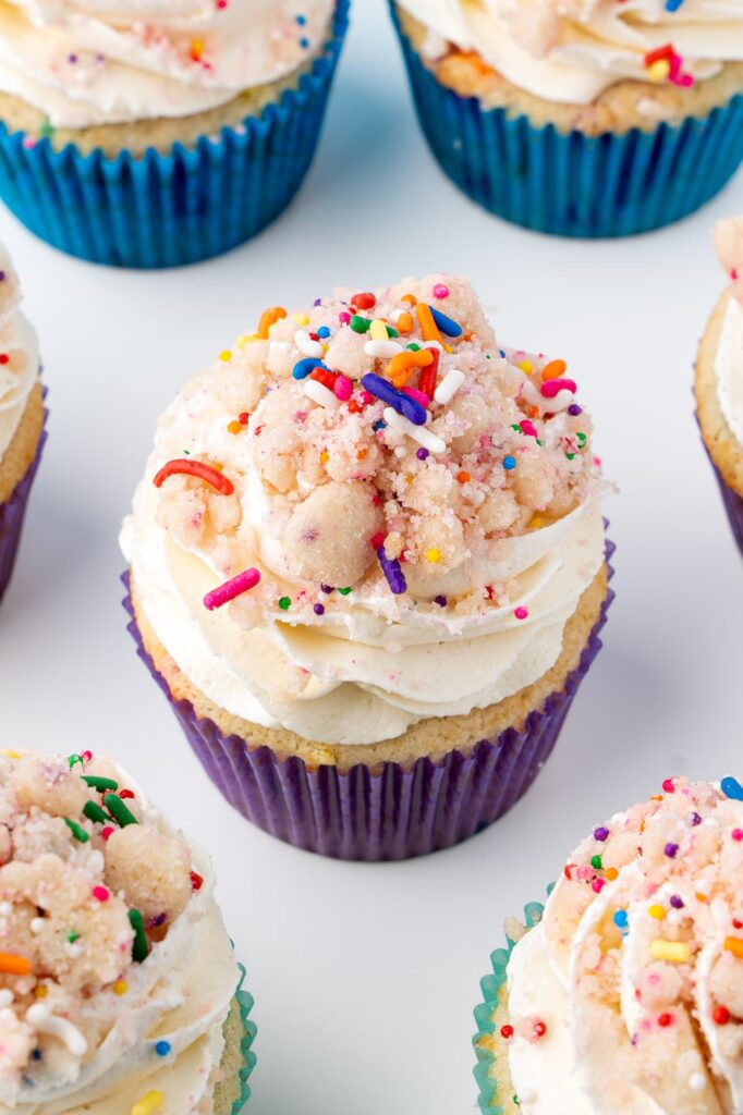 Funfetti cupcakes with cake batter frosting and birthday cake crumbs.