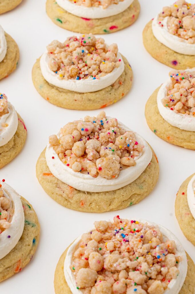 Thick funfetti sugar cookies with cake batter frosting and birthday cake crunch.