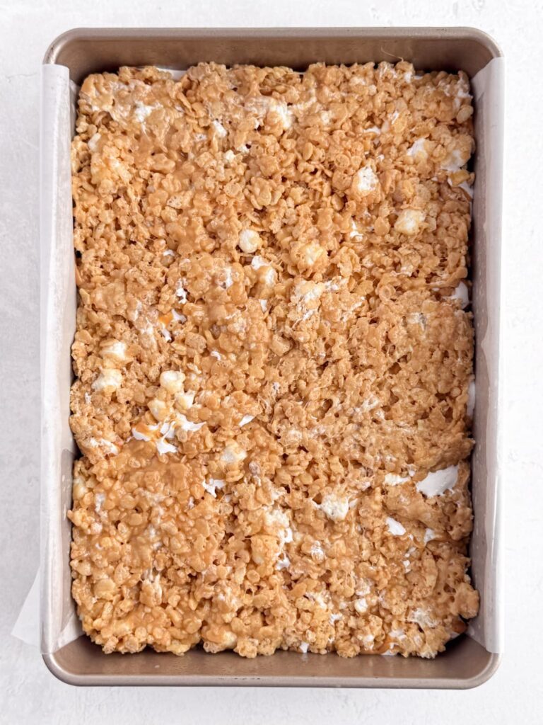 Peanut butter Rice Krispie treat bars in a baking pan.