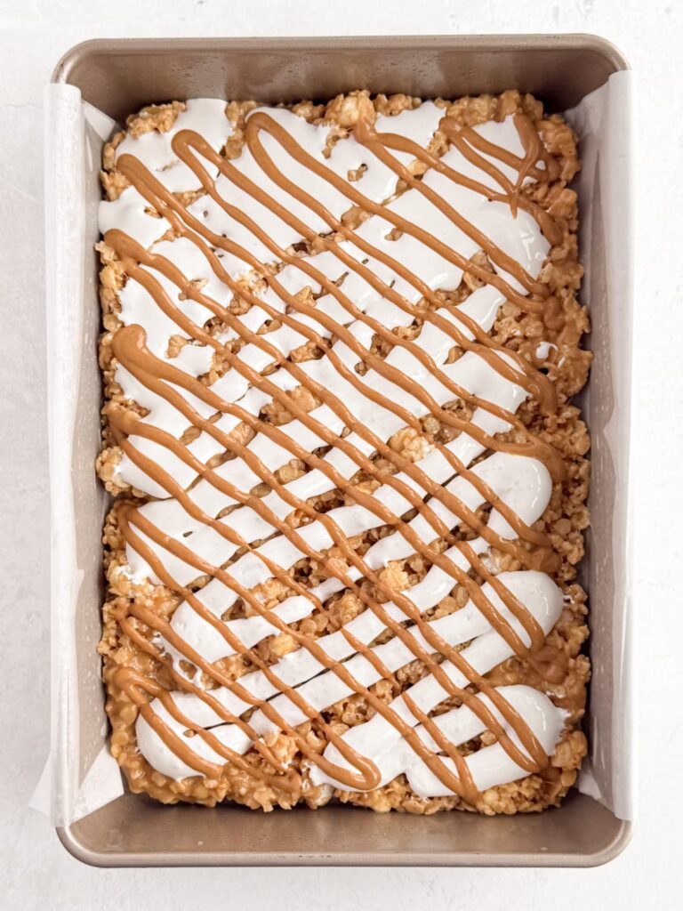 Marshmallow fluff and peanut butter piped on to the Rice Krispie treat layer.