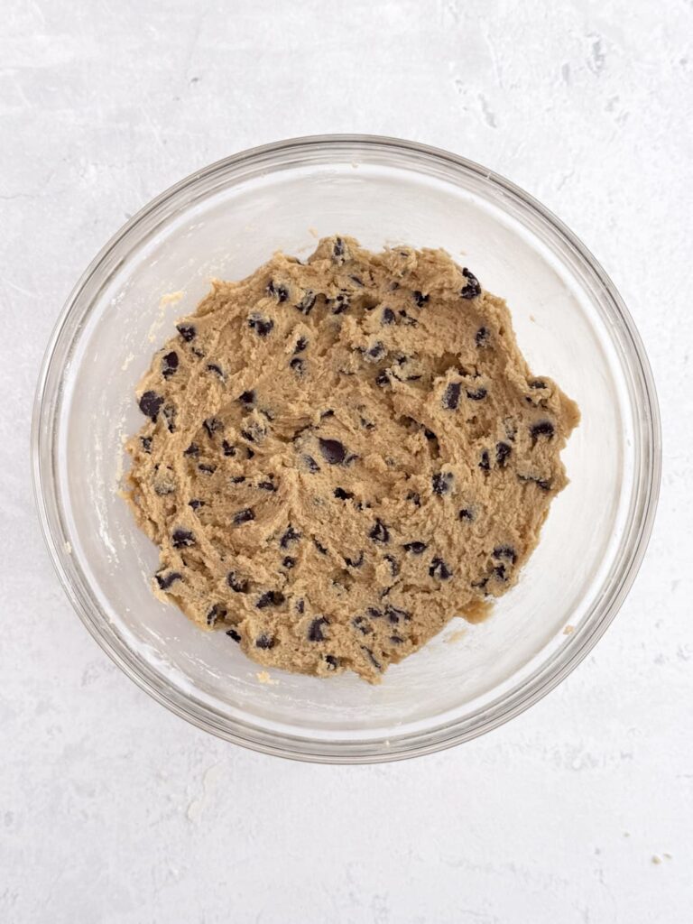 Chocolate chip cookie dough in a mixing bowl.