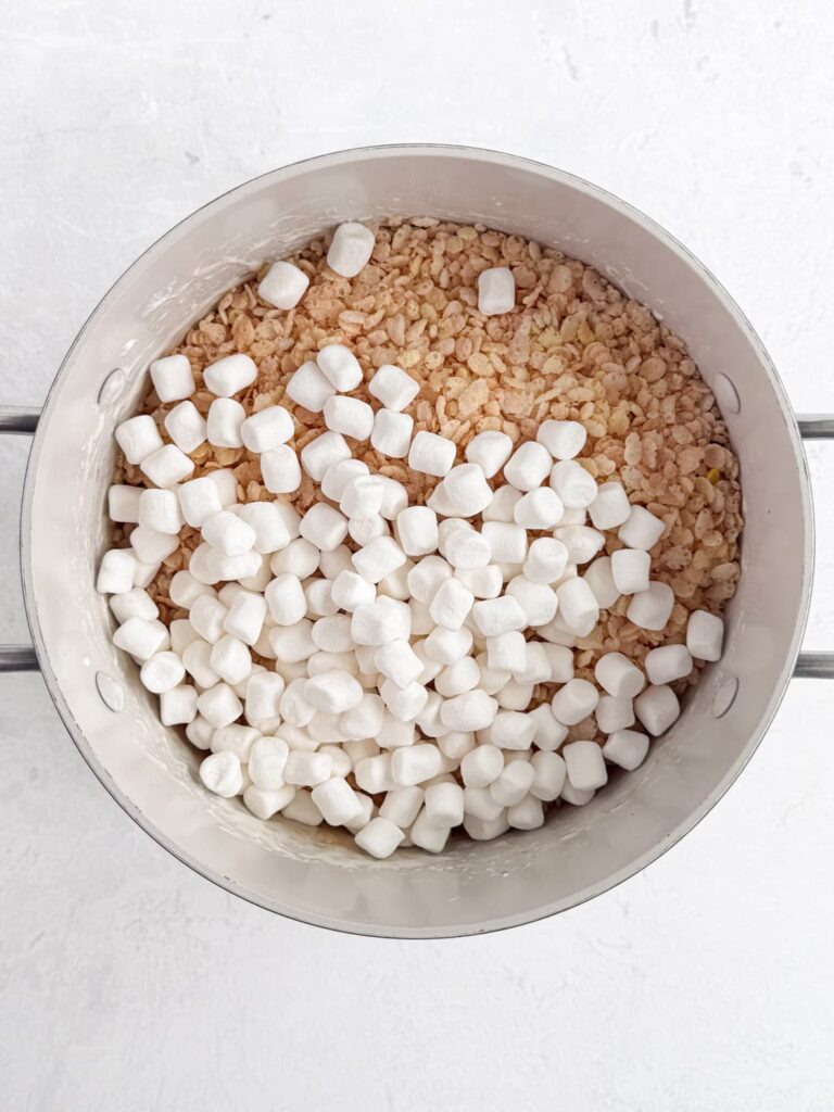 Rice Krispies cereal and mini marshmallows in a saucepan.
