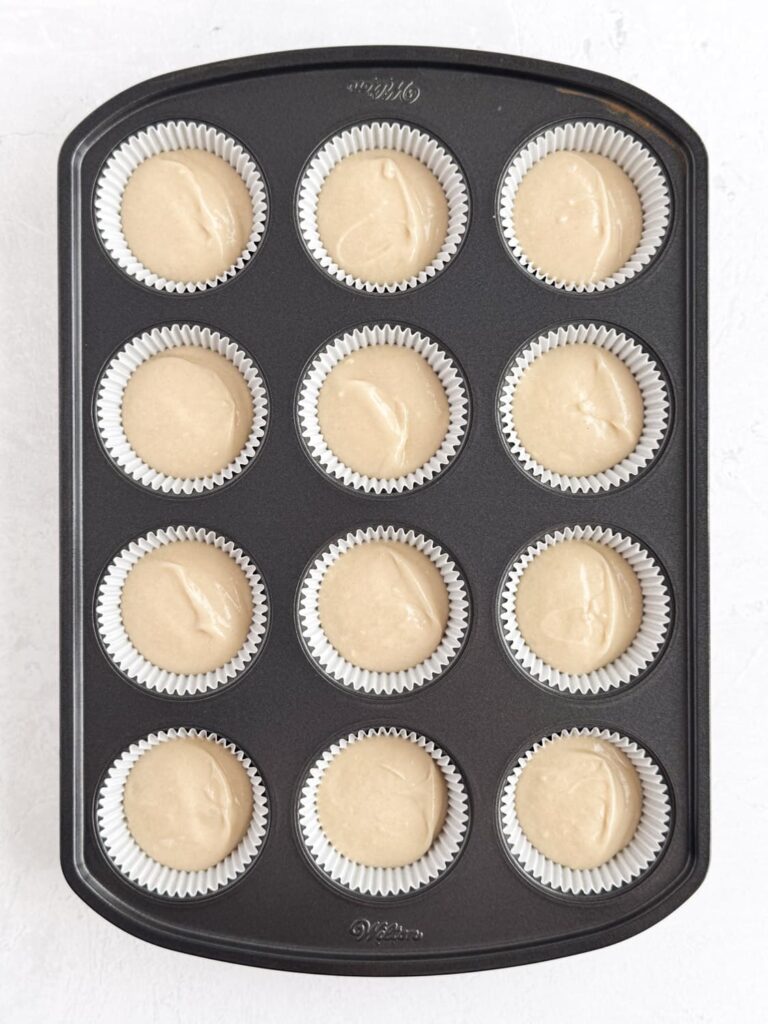 Vanilla almond cupcake batter in a cupcake pan.