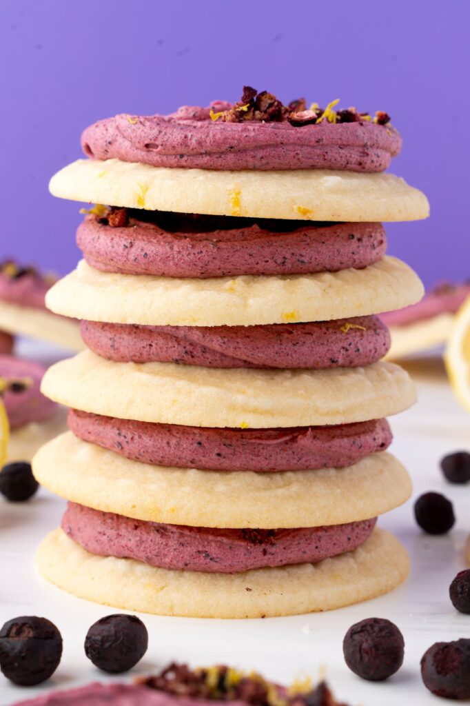 A stack of blueberry frosted lemon cookies.