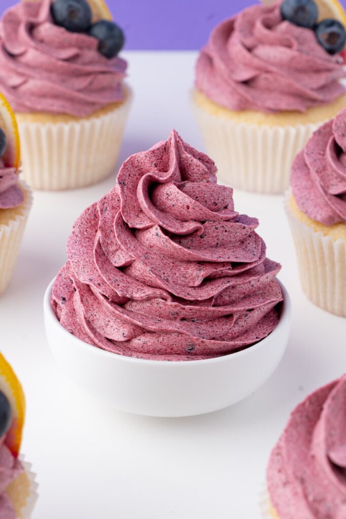 A swirl of blueberry frosting in a small bowl.