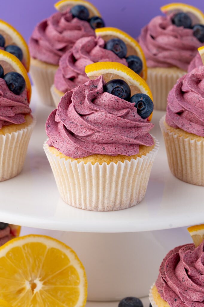 Blueberry lemon cupcakes on a cake stand.