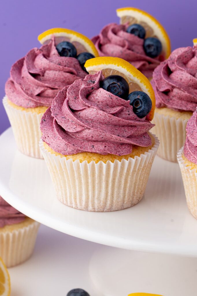 Blueberry lemon cupcakes on a cake stand.
