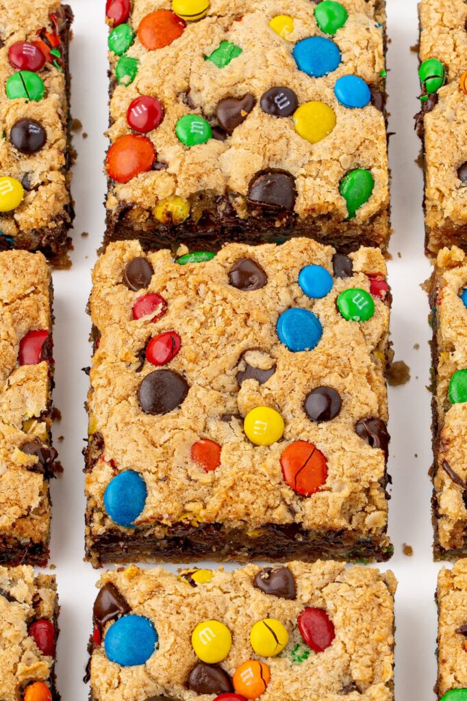 Chewy monster cookie bars with semisweet chocolate chips and M&M candies.