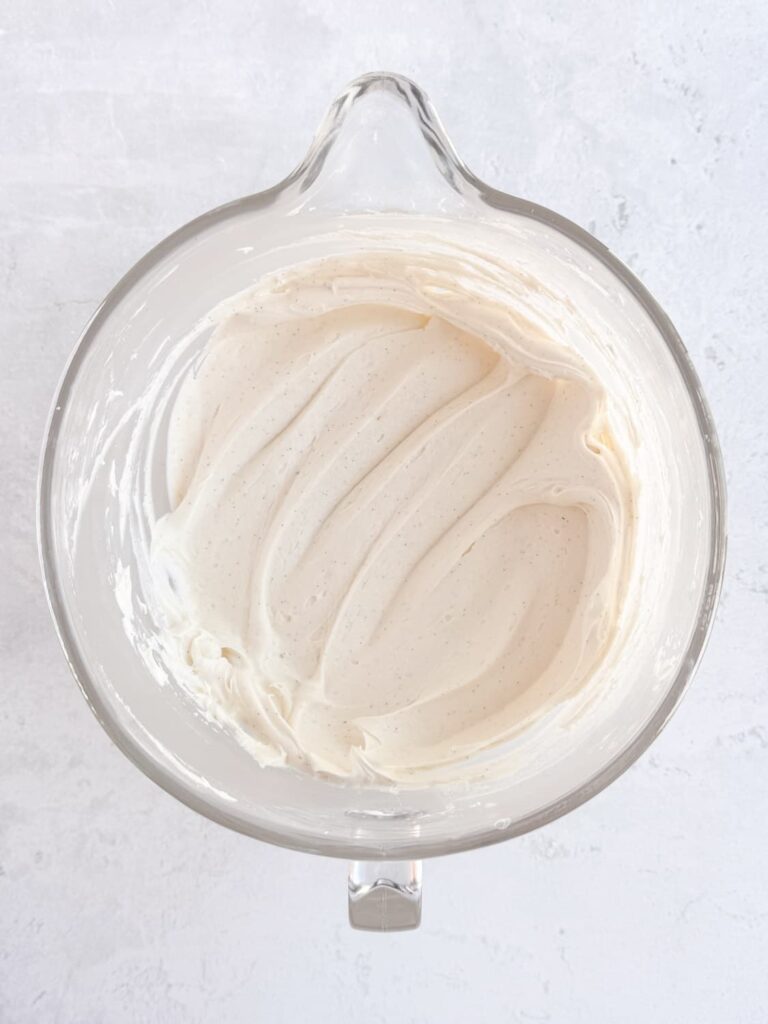 Smooth vanilla bean buttercream frosting in a mixing bowl.