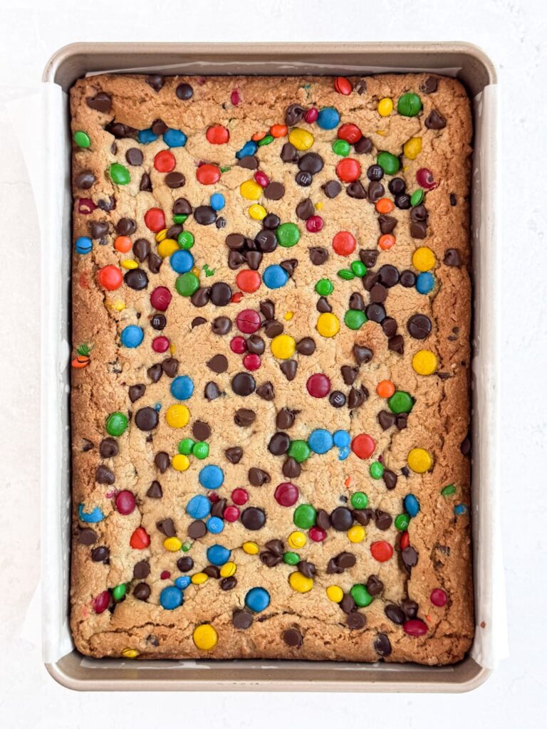 Baked monster cookie bars in a baking pan.