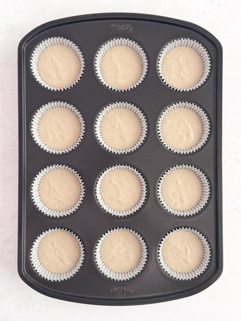 Vanilla bean cupcake batter in cupcake liners.