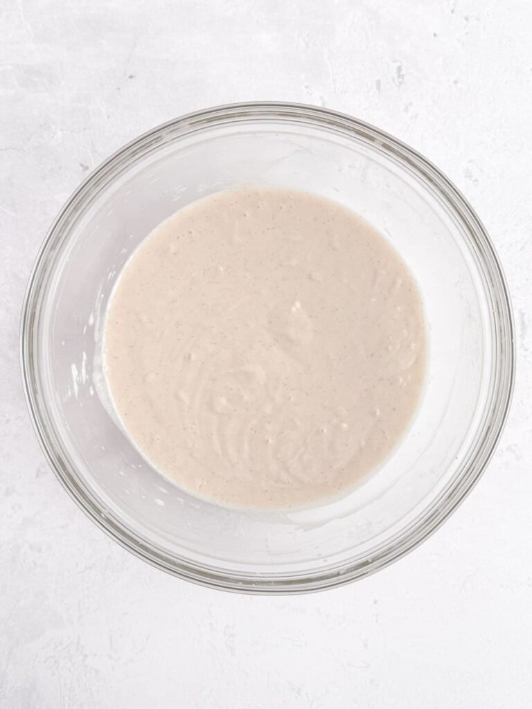 Vanilla bean cupcake batter in a mixing bowl.