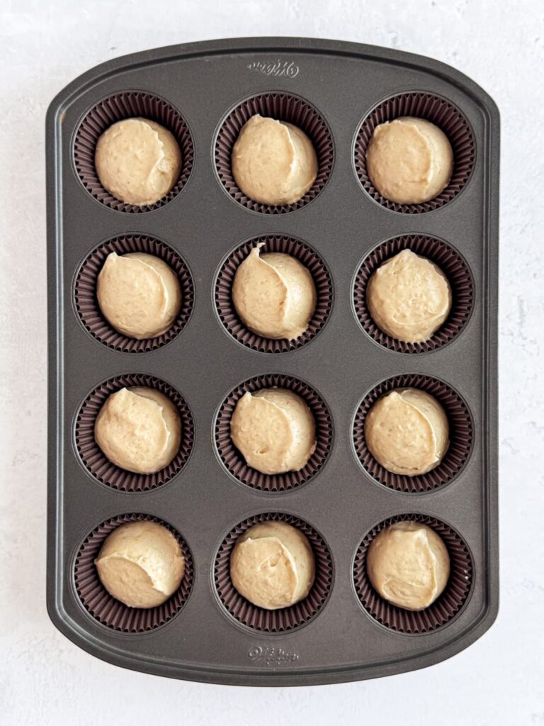 Graham cracker cake batter portioned into cupcake liners.