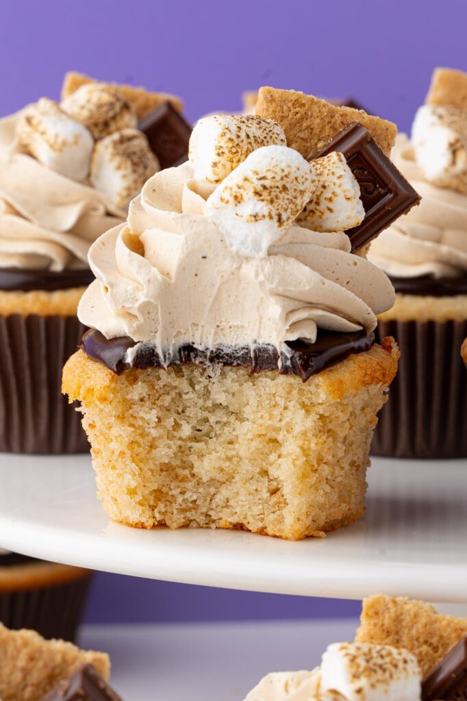 A bite out of a s'mores cupcake to show the interior texture of the cupcake.