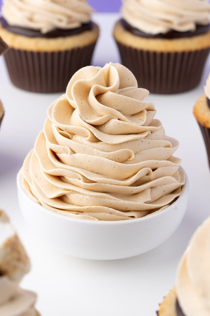 A swirl of toasted marshmallow frosting in a small white bowl.
