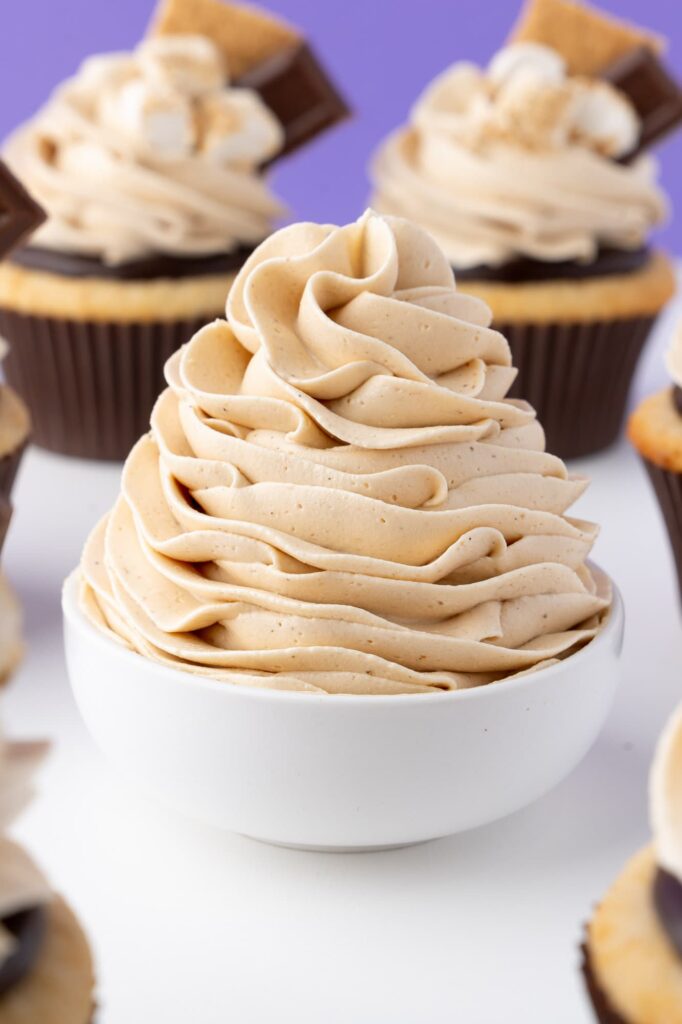 A swirl of toasted marshmallow frosting in a small white bowl.