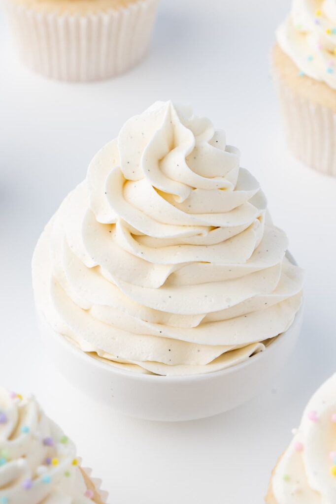 A swirl of vanilla bean buttercream with vanilla bean specks.
