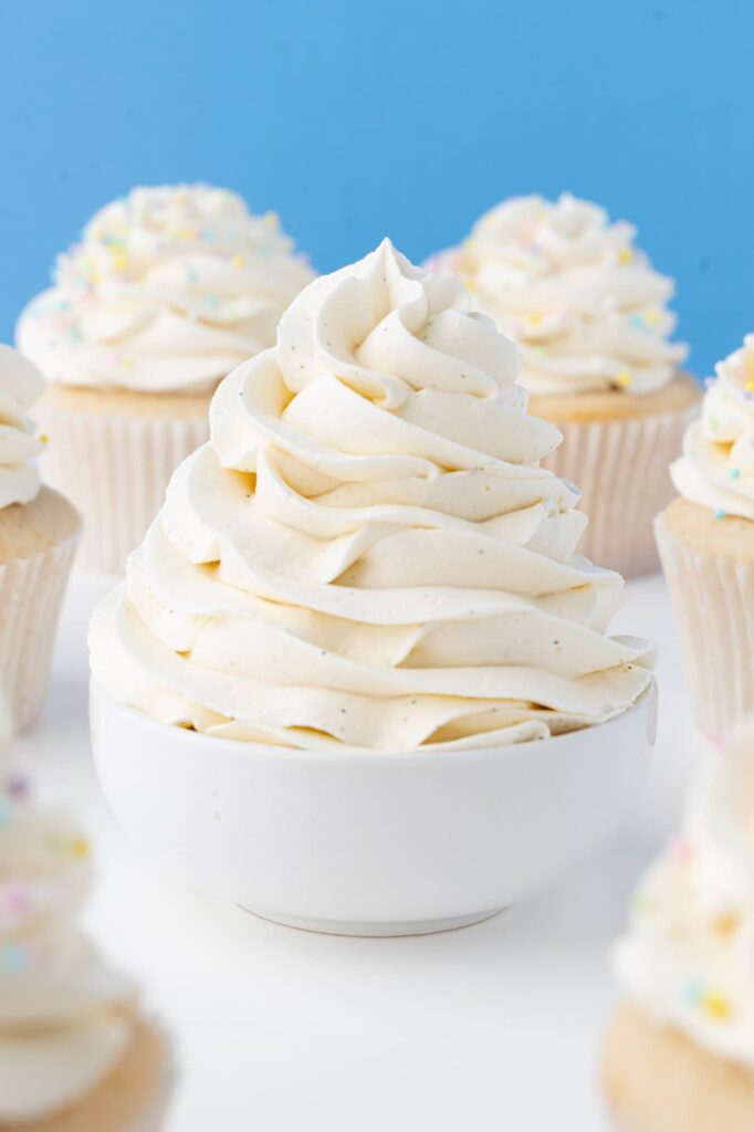 Vanilla bean buttercream frosting in a white bowl.