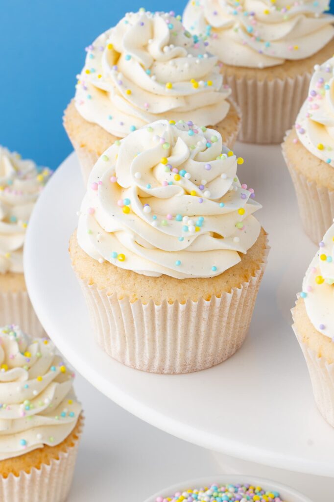 Vanilla bean cupcakes with vanilla frosting and sprinkles.