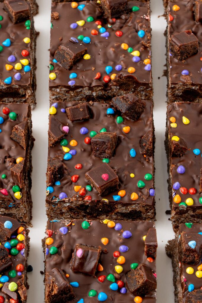 Chocolate rice krispie treats with brownie pieces and rainbow chip candies.