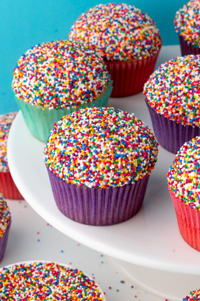 Dot cupcakes on a white cake stand.