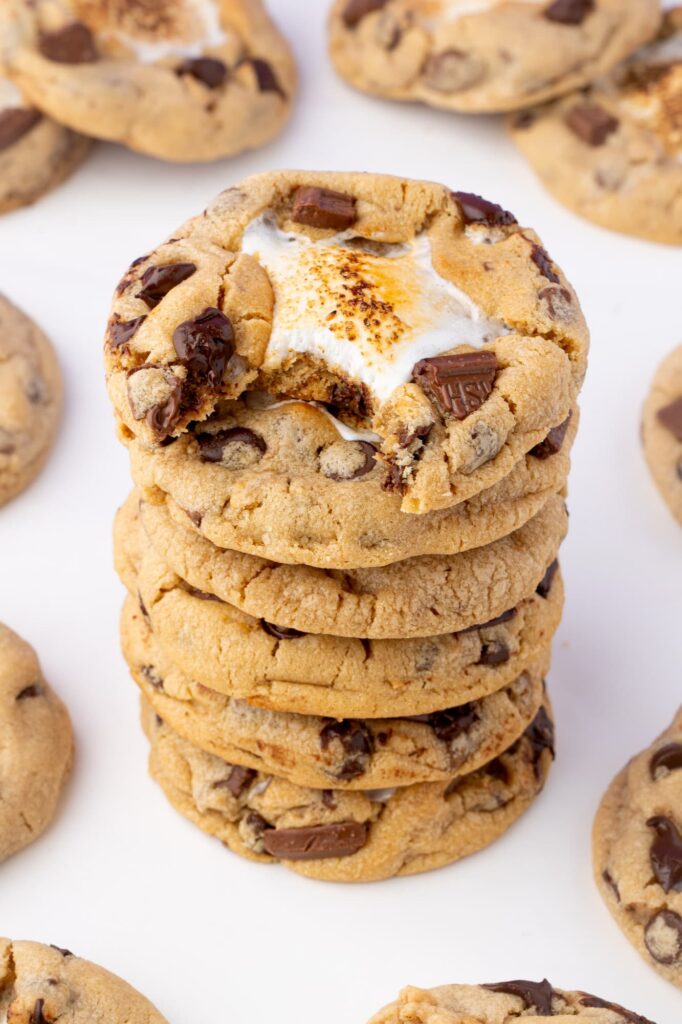 A stack of peanut butter s'mores cookies with a bite taken out of the top cookie.