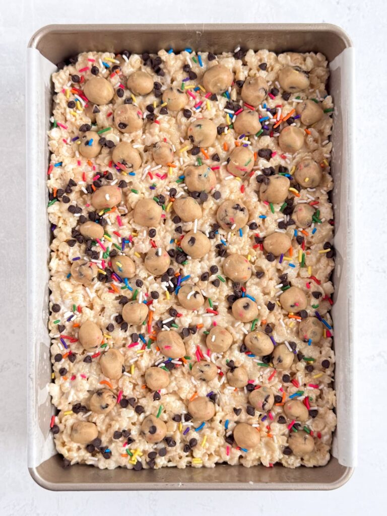 The finished cookie dough Rice Krispie treats in a baking pan.